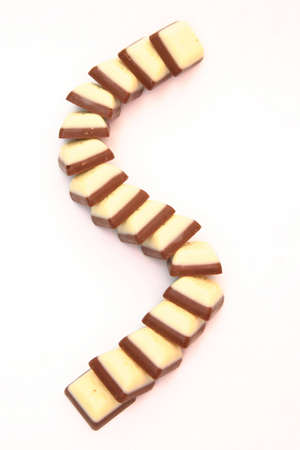 serpent made of dark and white chocolates isolated on whiteの写真素材