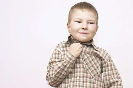 little cheeky boy making funny faces on white backgroundの写真素材