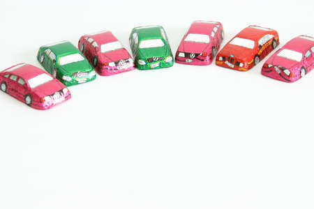 little chocolates in shape of car isolated on whiteの写真素材