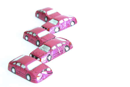 little chocolates in shape of car isolated on whiteの写真素材
