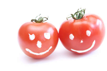 two happy, smiling tomatoes isolated on whiteの写真素材