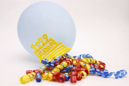blue balloon and birthday cake with colorful ribbons