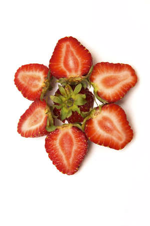 flower made of fresh, red strawberries isolated on whiteの写真素材