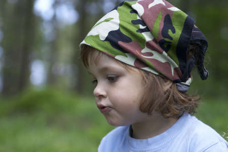 portrait of a child in the forest, on summertime trip