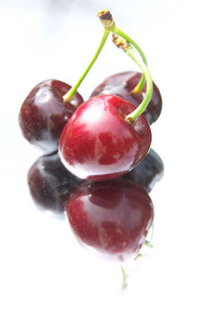 composition of red cherries on the mirror