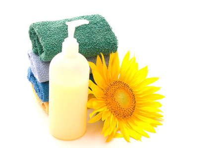 pile of towels, sunflower and liquid soap