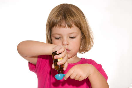 sick little girl with medicines, isolated on whiteの写真素材