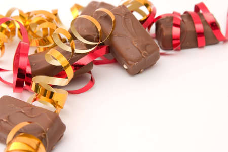 composition made of little chocolate bars and ribbonsの写真素材