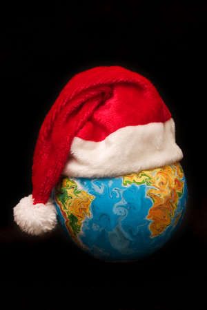 the Globe wearing Santas hat, on black backgroundの写真素材