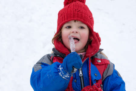 little happy girl having fun in the snowの写真素材