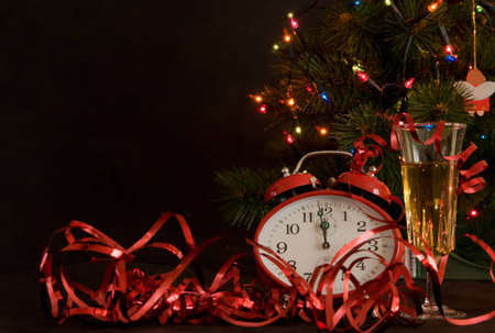 red clock and glass of champagne on Christmas backgroundの写真素材