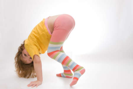 little, cute girl exercising isolated on white