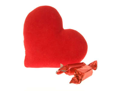 chocolates in colorful wrappings and red heart isolated on whiteの写真素材