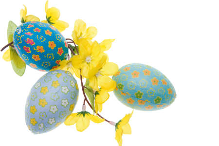 Easter eggs and yellow flowers isolated on white