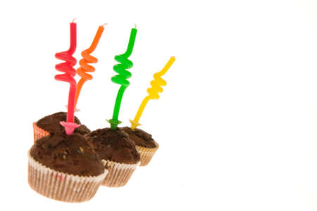 birthday chocolate muffins with twisted candle isolated on whiteの写真素材