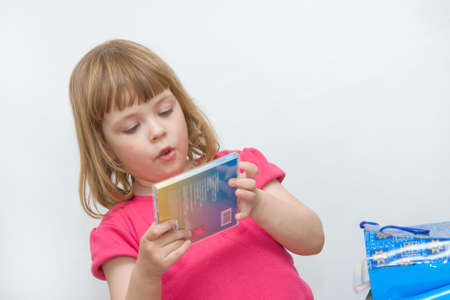 little girl choosing compact disc with her favourite music