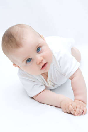 little, cute baby boy lying on white background