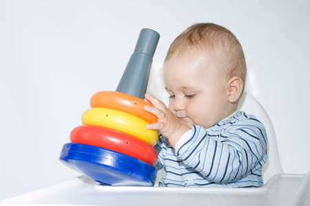 cute baby boy playing with colorful toysの写真素材