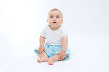 cute laughing baby boy sitting on white backgroundの写真素材