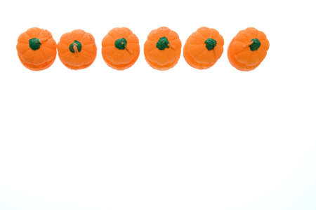 Halloween candles in shape of pumpkin isolated on whiteの写真素材