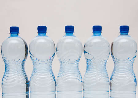 bottles of clear water with blue capの写真素材
