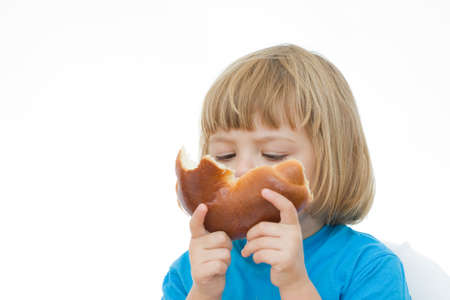 little girl in blue shirt eating breakfastの写真素材