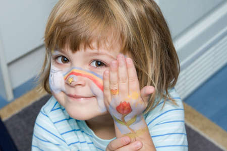 lovely, happy little  girl with painted face
