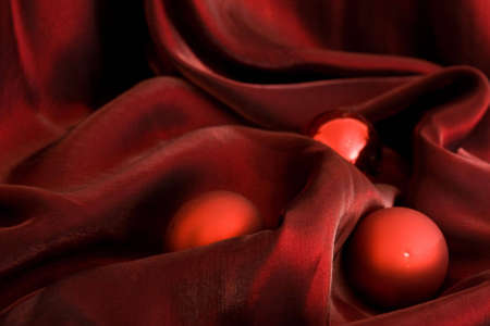 three red Christmas baubles on purple backgroundの写真素材