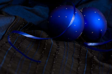 two Christmas baubles on blue backgroundの写真素材