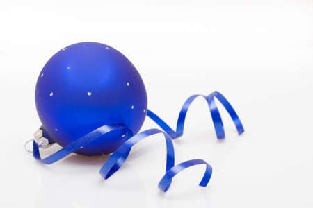 Christmas bauble and dancing ribbon isolated on whiteの写真素材