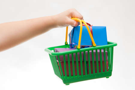 green shopping basket full of Christmas giftsの写真素材