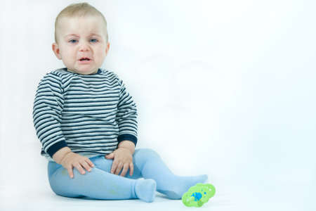 portrait of upset baby boy, on whiteの写真素材