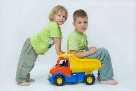 two brother playing together with colorful carの写真素材