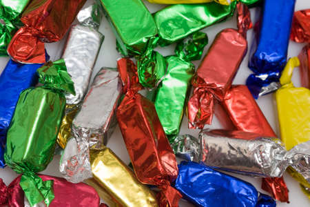 background of many colorful wrapped candiesの写真素材