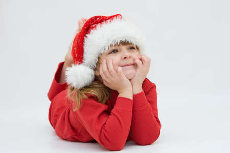 cute, little Santa girl, dreaming of Christmasの写真素材