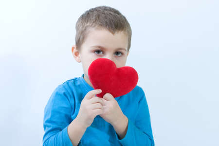 cute, little boy with heart on white backgroundの写真素材