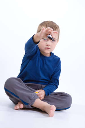 cute, little boy with toy car on whiteの写真素材