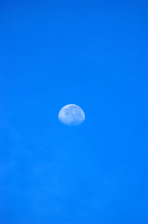 Moon in the blue sky at noon.の写真素材