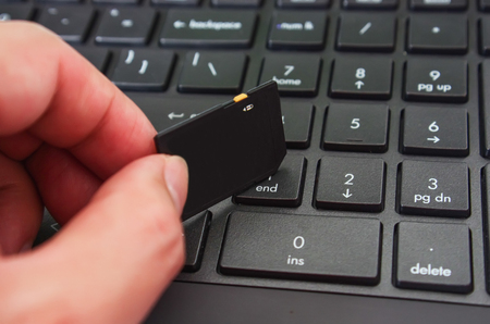 Storing data card on keyboardの写真素材