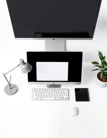 Computer with blank screen, keyboard, mouse, lamp and plant on white table