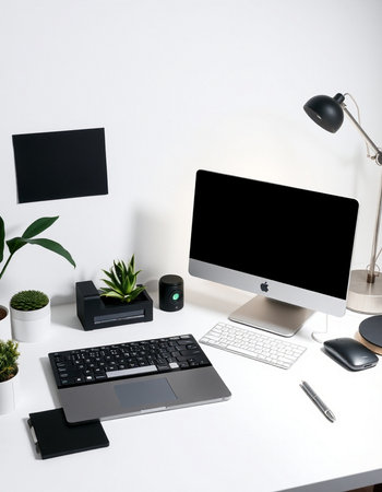 workplace with computer, keyboard, mouse, lamp, stationery and plants