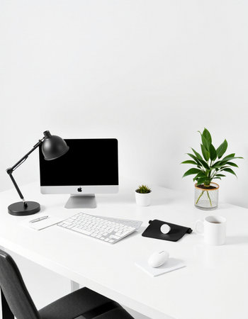 Workplace with computer, lamp, coffee cup and plant on white table