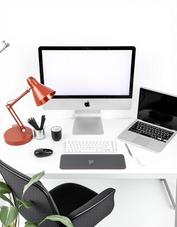 Modern workspace with blank screen computer monitor, laptop, coffee cup and other items on white...