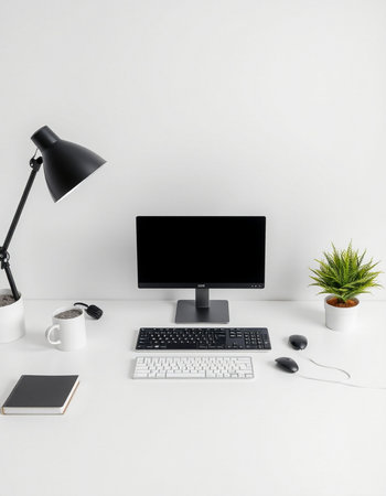Minimalist workspace with computer, coffee cup, keyboard and mouse on white background
