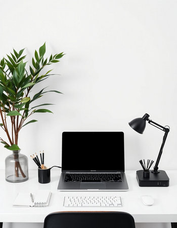 Modern workplace with blank screen laptop, coffee cup, stationery and plant on white background