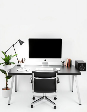workplace with computer, lamp and stationery on white wall background