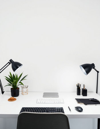 Front view of white office desk with laptop, stationery and plant