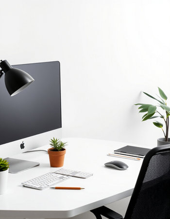 Workplace with computer, keyboard, mouse, lamp and plant on white table