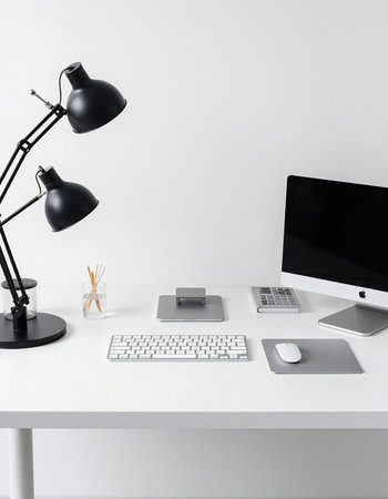 Office desk with computer, keyboard, mouse, mouse, lamp and other items