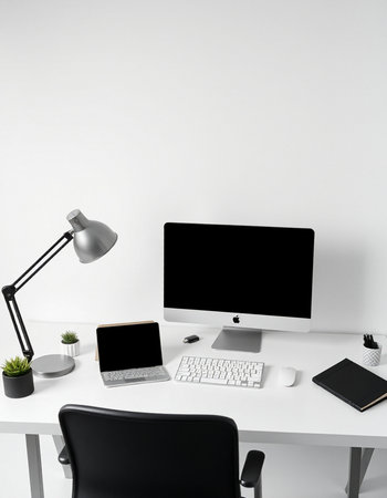 workplace with computer, lamp and stationery on white wall background